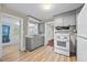 Bright kitchen featuring gray cabinets and white appliances at 1613 Old Wilson Rd, Rocky Mount, NC 27801