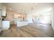 Open concept kitchen with white cabinets, granite island, and stainless steel appliances at 123 Johnson Ridge Way, Four Oaks, NC 27524