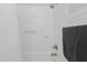Bathroom with white tile, shower/tub, and dark grey towels at 1905 Wagoner St, Durham, NC 27705