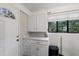 Laundry room with countertop, cabinets, and exterior door at 1905 Wagoner St, Durham, NC 27705