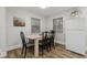 Light-filled dining area with wood table and four chairs at 1905 Wagoner St, Durham, NC 27705