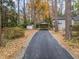 Asphalt driveway leading to house with carport and storage building at 1905 Wagoner St, Durham, NC 27705