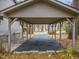 Covered carport with asphalt driveway, offering shade and parking convenience at 1905 Wagoner St, Durham, NC 27705