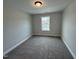 Bright bedroom with carpet flooring and a large window at 1017 Bostonian Dr, Knightdale, NC 27545