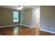 Spacious bedroom with hardwood floors, window and access to bathroom at 513 N Carr St, Mebane, NC 27302