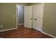 Spacious bedroom closet with double doors and hardwood floors at 513 N Carr St, Mebane, NC 27302