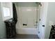 Clean bathroom with a bathtub, shower, and window at 513 N Carr St, Mebane, NC 27302