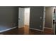 Well-lit bedroom closet with wood floors and hanging rod at 513 N Carr St, Mebane, NC 27302