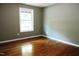 Simple bedroom with hardwood floors and a window at 513 N Carr St, Mebane, NC 27302