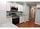 Modern kitchen with white cabinets and granite countertops at 513 N Carr St, Mebane, NC 27302