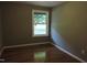Bright bedroom featuring hardwood floors and a large window at 513 N Carr St, Mebane, NC 27302
