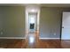 Hardwood floor hallway with access to bathroom and bedroom at 513 N Carr St, Mebane, NC 27302