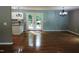 Open dining room with hardwood floors and access to the kitchen at 513 N Carr St, Mebane, NC 27302