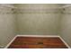 Walk-in closet with wire shelving and hardwood floors at 513 N Carr St, Mebane, NC 27302