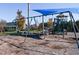 Swings and play equipment under shade sail at 75 Bur Oak Ct, Pittsboro, NC 27312