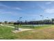 Well-lit tennis court with walking path nearby at 75 Bur Oak Ct, Pittsboro, NC 27312