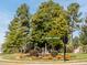 Landscaped community entrance with street signs and homes at 75 Bur Oak Ct, Pittsboro, NC 27312
