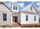 Front entrance of a charming two-story home with a brick walkway and landscaping at 35 Uptown Rd, Zebulon, NC 27597