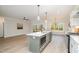 Open concept kitchen with a large island and stainless steel appliances at 35 Uptown Rd, Zebulon, NC 27597