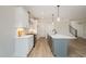 Modern kitchen with white cabinets, large island, and stainless steel appliances at 35 Uptown Rd, Zebulon, NC 27597