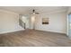 Spacious living room with hardwood floors, a ceiling fan, and access to a deck at 35 Uptown Rd, Zebulon, NC 27597