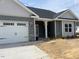 Gray two-story house with white double garage doors at 120 Watermelon Dr, Franklinton, NC 27525