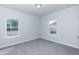 Bright bedroom with two windows and gray carpeting at 50 Lemon Drop Ln, Franklinton, NC 27525