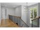 Bright hallway showcasing hardwood floors and a stylish chandelier at 1404 Eden Ln, Raleigh, NC 27608