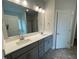 Double vanity bathroom with gray cabinets and quartz countertop at 90 Watermelon Dr, Franklinton, NC 27525
