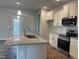 Modern kitchen with white cabinets, granite countertops, and stainless steel appliances at 90 Watermelon Dr, Franklinton, NC 27525