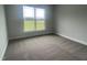 Bright bedroom with carpeted floor and large window offering natural light at 90 Watermelon Dr, Franklinton, NC 27525