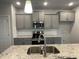 Modern kitchen with gray cabinets, granite countertops and stainless steel appliances at 90 Watermelon Dr, Franklinton, NC 27525