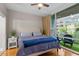 Main bedroom with king bed, balcony access, and city views at 3201 Environ Way # Bldg 3000, Chapel Hill, NC 27517
