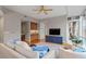Living room with hardwood floors, ceiling fan, and built-in entertainment center at 3201 Environ Way # Bldg 3000, Chapel Hill, NC 27517