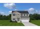 Two-story house with taupe siding, a two-car garage, and a green door at 278 Gianna Dr, Lillington, NC 27546