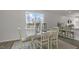Dining area with a farmhouse table and view into the kitchen at 723 Dorset Stream Dr, Fuquay Varina, NC 27526