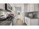 Modern kitchen with white cabinets, granite countertops, and a door to backyard at 723 Dorset Stream Dr, Fuquay Varina, NC 27526