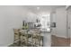 Kitchen island with granite countertop and three wooden stools at 723 Dorset Stream Dr, Fuquay Varina, NC 27526