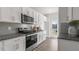 Modern kitchen with stainless steel appliances and granite countertops at 723 Dorset Stream Dr, Fuquay Varina, NC 27526