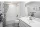 Clean bathroom with white vanity, shower/tub combo, and gray tile floor at 8916 Stratus St, Willow Springs, NC 27592