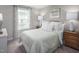 Light and airy bedroom featuring a light teal comforter and wood nightstands at 8916 Stratus St, Willow Springs, NC 27592