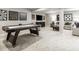 Finished basement features a game table, seating area, and large TV, perfect for entertainment at 8813 Tartan Clan Dr, Willow Springs, NC 27592
