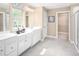 Double vanity bathroom with a walk-in shower and walk-in closet at 8813 Tartan Clan Dr, Willow Springs, NC 27592
