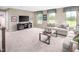 Spacious bonus room with comfortable seating and a large TV at 8813 Tartan Clan Dr, Willow Springs, NC 27592