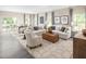 Spacious living room with a large sectional sofa and ottoman at 8813 Tartan Clan Dr, Willow Springs, NC 27592