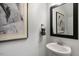 Small powder room with pedestal sink and mirror at 2238 Cherry Top Dr, Fuquay Varina, NC 27526