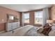 Serene bedroom with a comfortable bed, dresser, and natural light at 2232 Cherry Top Dr, Fuquay Varina, NC 27526