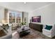 Relaxing living room with comfy seating, large windows, and a wooden coffee table at 2232 Cherry Top Dr, Fuquay Varina, NC 27526