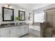 Spa-like bathroom featuring a soaking tub, double vanity, and a walk-in shower at 2232 Cherry Top Dr, Fuquay Varina, NC 27526