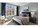 Bright bedroom with large window, plush bed, and comfortable chair at 2232 Cherry Top Dr, Fuquay Varina, NC 27526